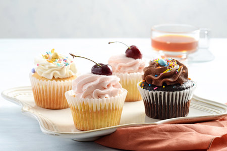 closeup assorted cupcakes with sprinkles on a plateの写真素材