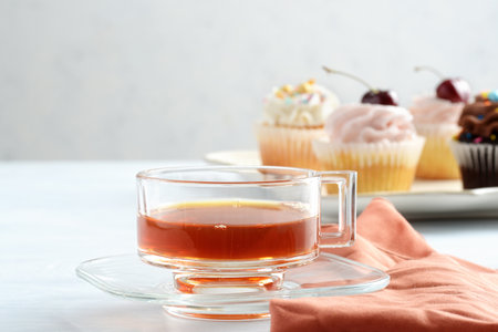 cup of tea in glass cup with brown napkinの写真素材