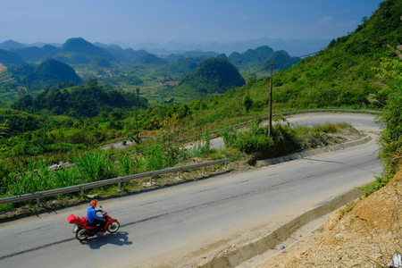 Ha Giang / Vietnam - 01/11/2017: Motorbiking backpackers on winding roads through valleys and karst mountain scenery in the North Vietnamese region of Ha Giang / Dong Van.のeditorial素材