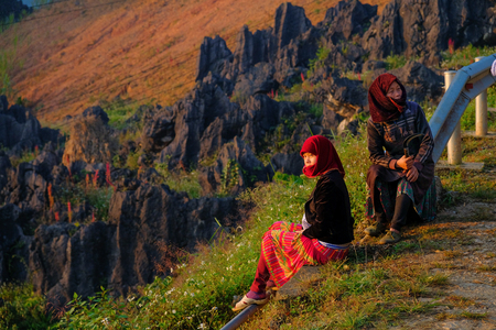 Ha Giang / Vietnam - 01/11/2017: Two local Vietnamese women in traditional clothes looking at the sunrise and mountain scenery in the North Vietnamese region of Ha Giang / Dong Van.のeditorial素材
