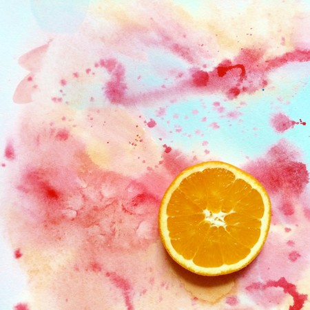 slice an orange on a motley background right in the cornerの写真素材