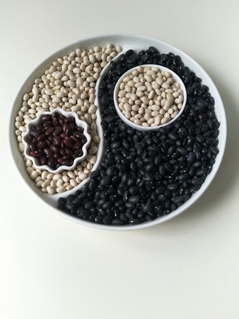 three colors of beans on a Yin Yang plate
