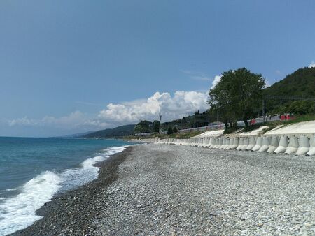 summer landscape with sea, mountains, train, skyの写真素材