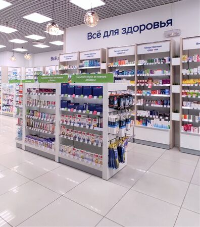Moscow, Russia-Sept. 5, 2019: All for health, medicine, all for beauty, dietary Supplements, oral care, vitamins buy profitably. The assortment of pharmacies, vitamins boxes and bottles of medicines are laid out on the shelves of the showcase. White wall のeditorial素材