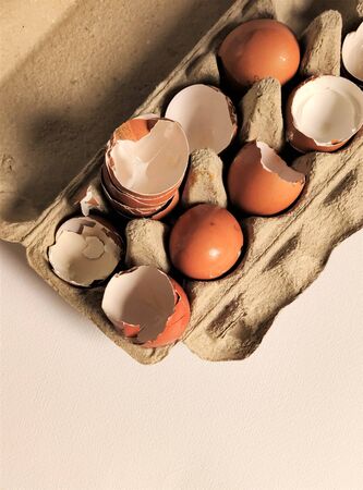 Fragment, shell halves of broken eggs in cardboard cells, top view, flat layout, close-up, aerial photography, food waste, eco-friendly recycling.の写真素材