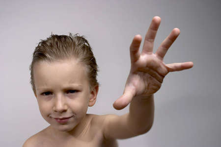 kid posing with serious look. Focus on face.の写真素材