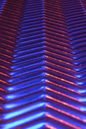 Close-up of metal plate under low light.
