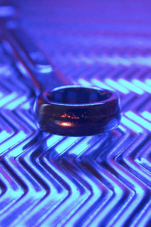 Tools on metal plate under low light.