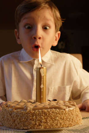kid posing when blowing birthday candle.の写真素材