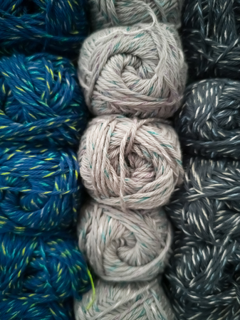Skeins with different colors of threads for knitting, for needlework. Abstract background with...