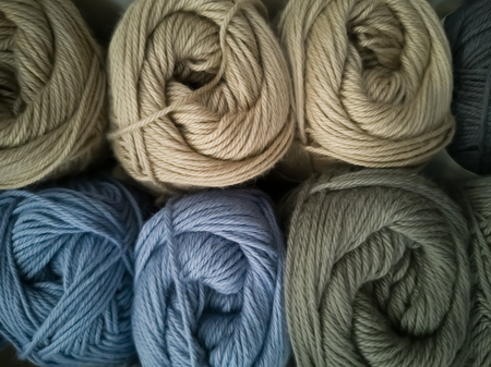 Skeins with different colors of threads for knitting, for needlework. Abstract background with...