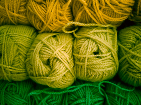 Skeins with different colors of threads for knitting, for needlework. Abstract background with colorful hanks.の写真素材