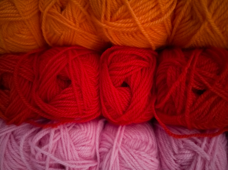 Skeins with different colors of threads for knitting, for needlework. Abstract background with...