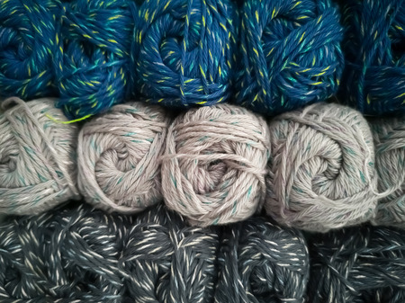 Skeins with different colors of threads for knitting, for needlework. Abstract background with...