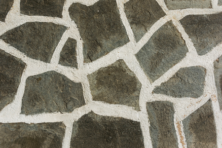 The surface of the stone floor with white seams. Abstraction.