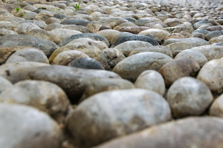 closeup cobblestone, pebble old pavement, ancient stone road