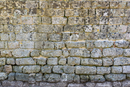 Old rough, weathered Stone wall. Ancient masonry.の写真素材
