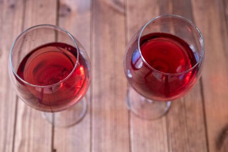 two glasses of red wine on a wooden table, romanticの写真素材