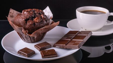 Chocolate muffin, Chocolate and cup of black coffee on the table.の写真素材