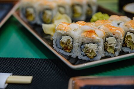 Fresh salmon sushi with avocado, salmon maki roll asian food restaurant.の写真素材