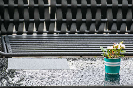 Table with water drops in a street cafe. Empty Cafe after the rain.
