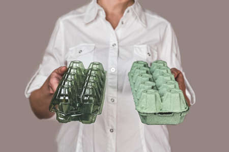 selection of ecological packaging. the girl holds in her hands two packages for eggs.