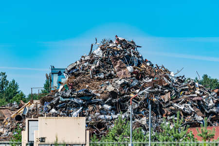 A pile of metal waste in the open air collected for recycling. Scrap metal on recycling site.の写真素材