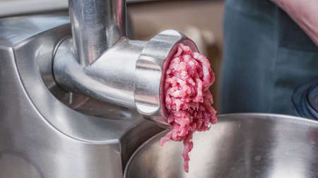 Cooking minced pork in an electric meat grinder. meat grinder with freshly ground meat.の写真素材