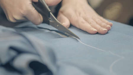 cutting the fabric with sharp scissors. Cut the fabric with tailor's scissors.の写真素材