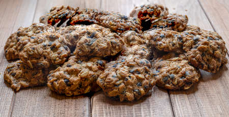 Homemade fragrant fresh baked goods. Oatmeal cookies lie on a wooden table.