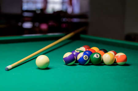 Colorful billiard balls and cue on a green table. billiard game in the club. snooker,の写真素材