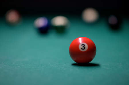 Close-up billiard red ball number 3. Colorful billiard balls on the green table. snooker and pool