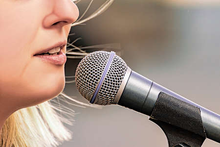 A woman speaks into a microphone during a protest on International Women's Day.の写真素材