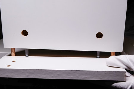 close-up of the white cabinet furniture assembly process. DIY