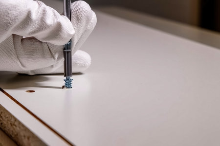 tightening a screw with a screwdriver, furniture assembly process close-upの写真素材
