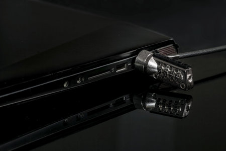 Laptop locked with cable lock. security concept. Kensington Security Slotの写真素材