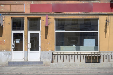 Abandoned shop windows. Abandoned grocery store building exterior.