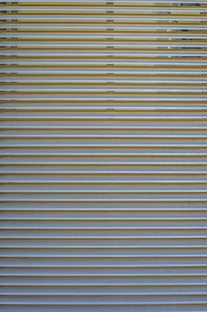 Metal ribbed sheet. abstract vertical textural linear background.の写真素材