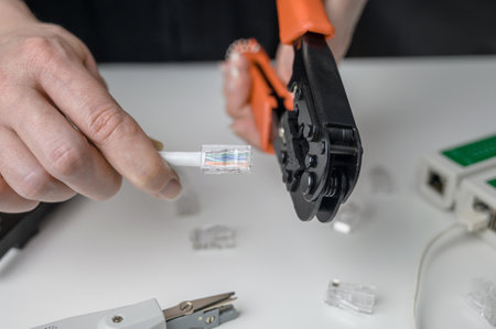 cable twisting tool UTP Cat 5 ethernet twisted pair, connecting procedure UTP cable, RJ45 LAN cable crimping, going to RJ45 connector crimping.の写真素材