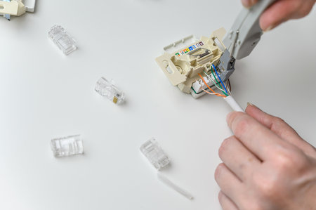installing a wall ethernet socket. Connecting wires to an socket.の写真素材