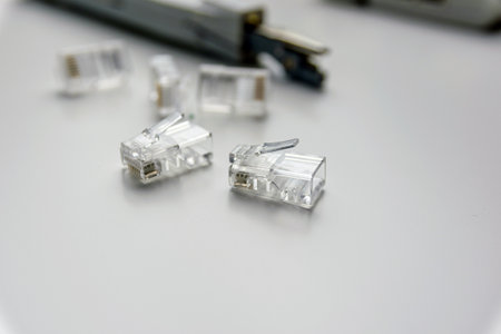 close-up of several rj45 connectors and other tools on a white table.の写真素材