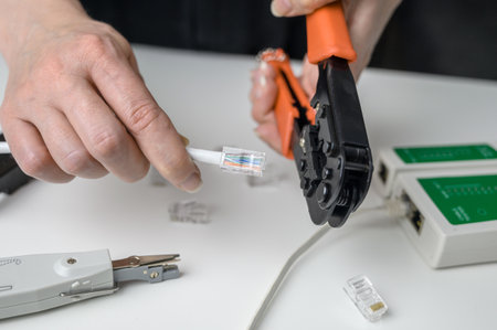 RJ45 network cable crimping with crimping tool, cable twisting tool, twisted pair Ethernet UTP Cat 6の写真素材