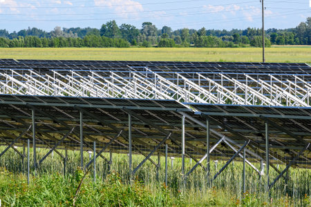 solar energy photovoltaic panels on green field and sky background, green clean alternative energy concept.の写真素材