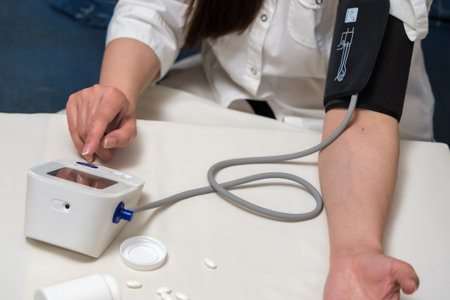 a woman suffering from high blood pressure uses a tonometer.