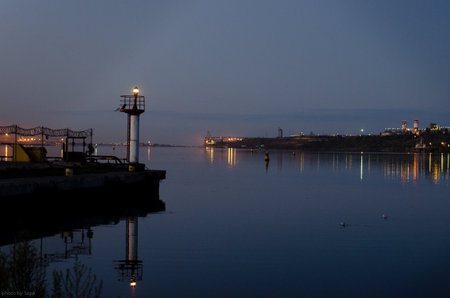 Seaport in a provincial town. Night. Port lights are reflected in the water.の写真素材