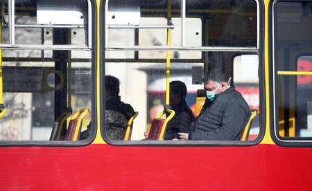 Warsaw, Poland, April 16, 2020: Warsaw during first day with hiding nose and mouth restriction during corona virus quarantine, people in public communicationのeditorial素材