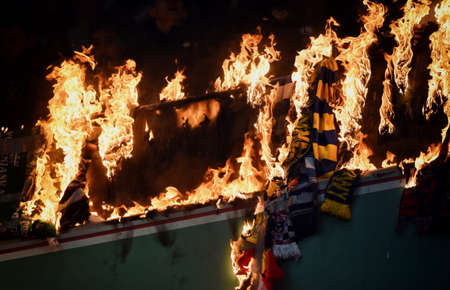 WARSAW, POLAND - NOVEMBER 28, 2021: Polish Football League game Legia Warszawa - Jagiellonia Bialystok, Legia fans set fire to scarves and flags of other clubsのeditorial素材