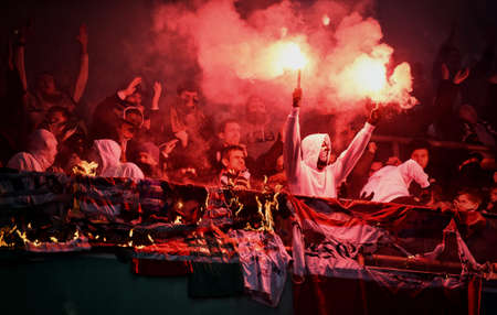 WARSAW, POLAND - NOVEMBER 28, 2021: Polish Football League game Legia Warszawa - Jagiellonia Bialystok, Legia fans set fire to scarves and flags of other clubsのeditorial素材