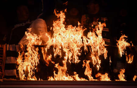 WARSAW, POLAND - NOVEMBER 28, 2021: Polish Football League game Legia Warszawa - Jagiellonia Bialystok, Legia fans set fire to scarves and flags of other clubsのeditorial素材