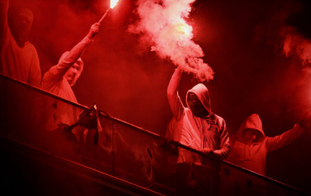 WARSAW, POLAND - NOVEMBER 28, 2021: Polish Football League game Legia Warszawa - Jagiellonia Bialystok, Legia fans set fire to scarves and flags of other clubsのeditorial素材